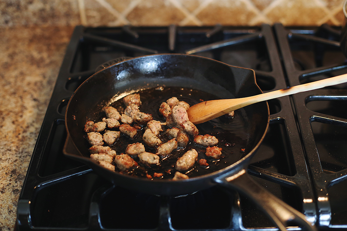 Sausage cooking in cast iron pan